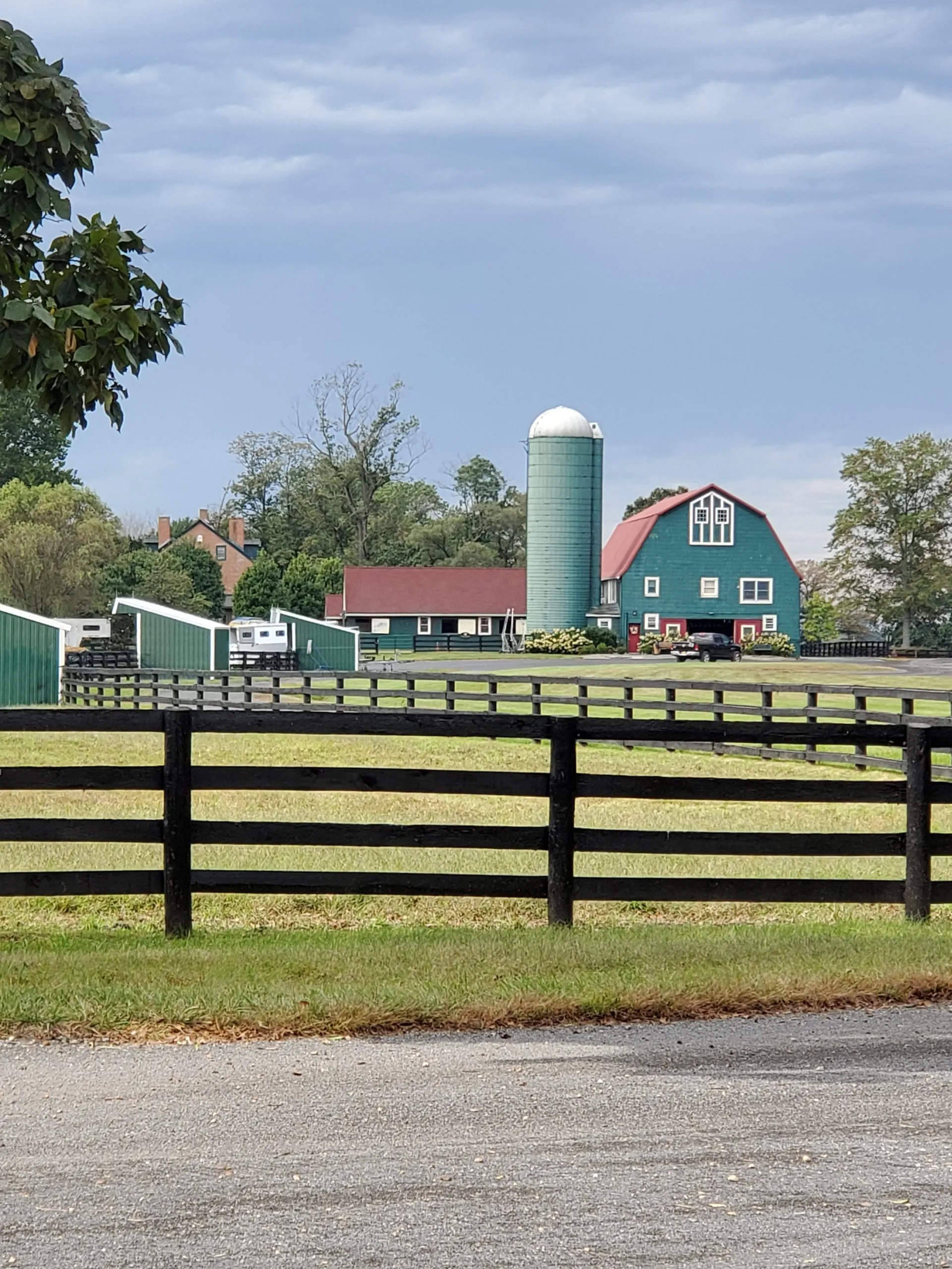 The teal barn and white silo at Joie de Vie Farm