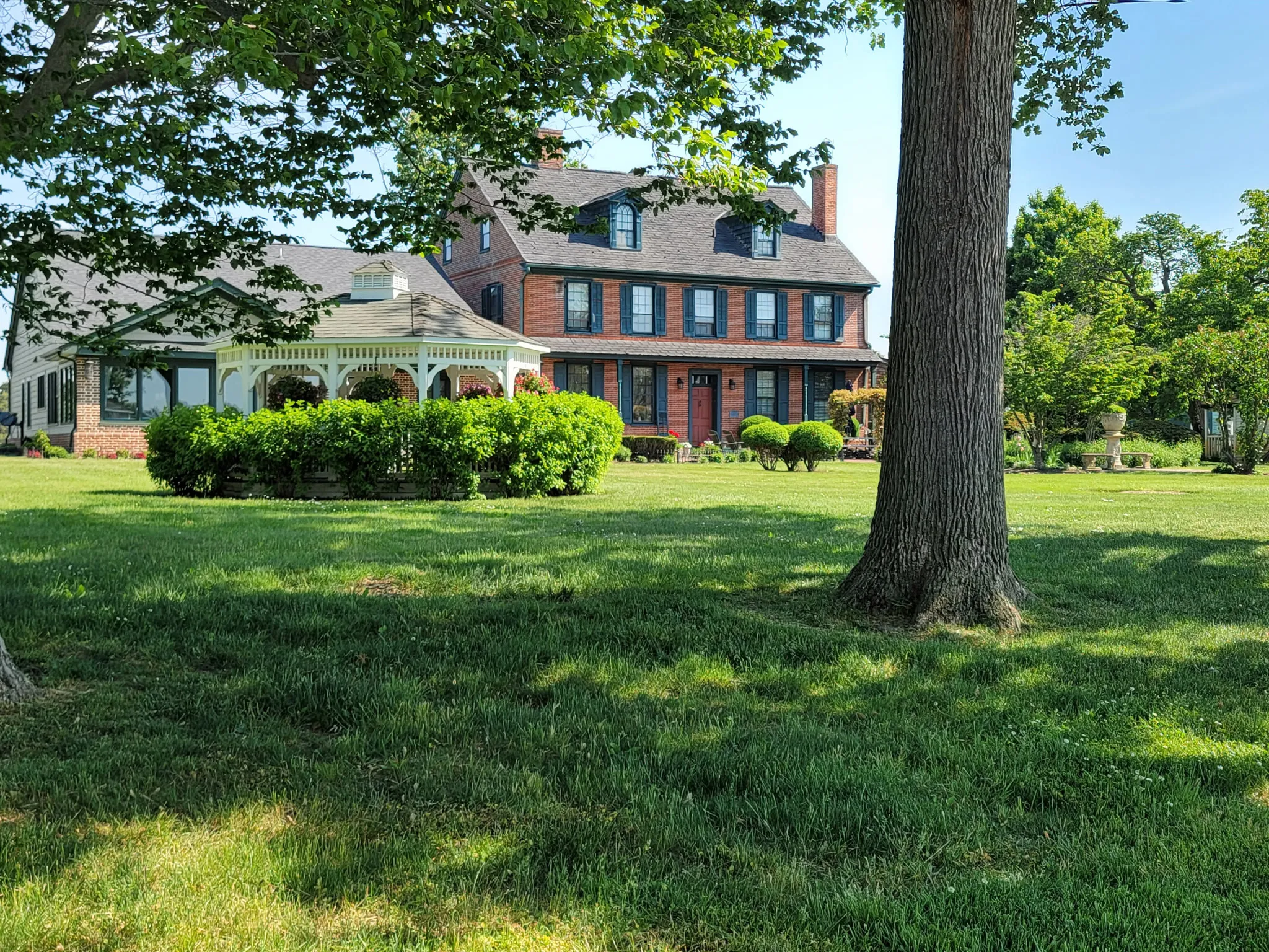 The brick manor house and wrap-around porch on the Joie de Vie Farm grounds